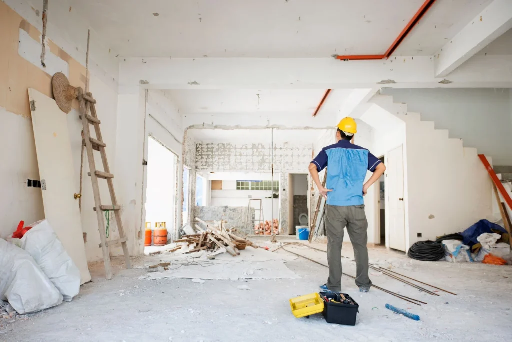 Home renovation in progress with a contractor reviewing the space